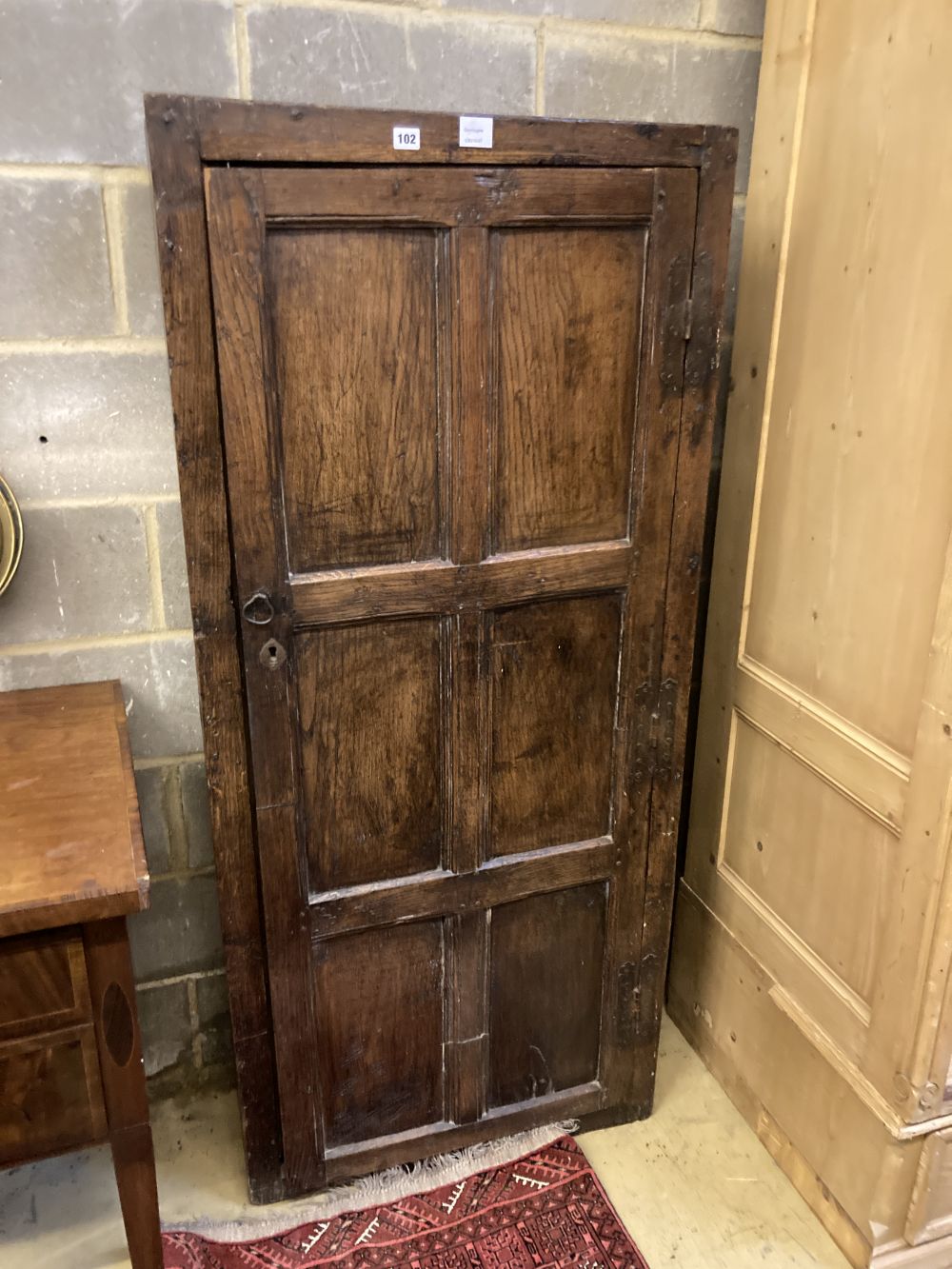 An 18th century panelled oak cupboard, width 74cm depth 30cm height 166cm